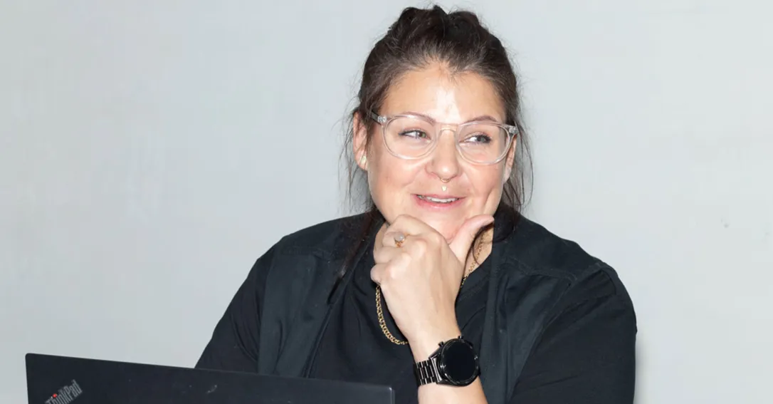 Bild på en kvinna som ler och håller sin vänstra hand lutat mot hakan.