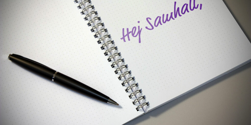 Ett block och en penna, på blocket står det "Hej Samhall"